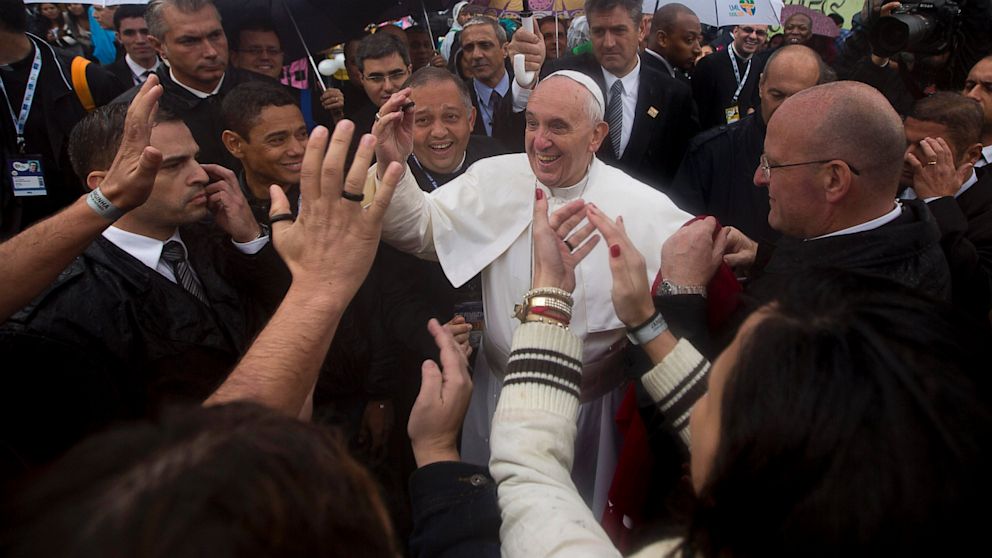 PHOTO: People greet Pope Francis, center, as he visits the Varginha slum in Rio de Janeiro, Brazil on July 25, 2013. Francis on Thursday visited one of Rio de Janeiros shantytowns, or favelas, a place that saw such rough violence in the past that its kn