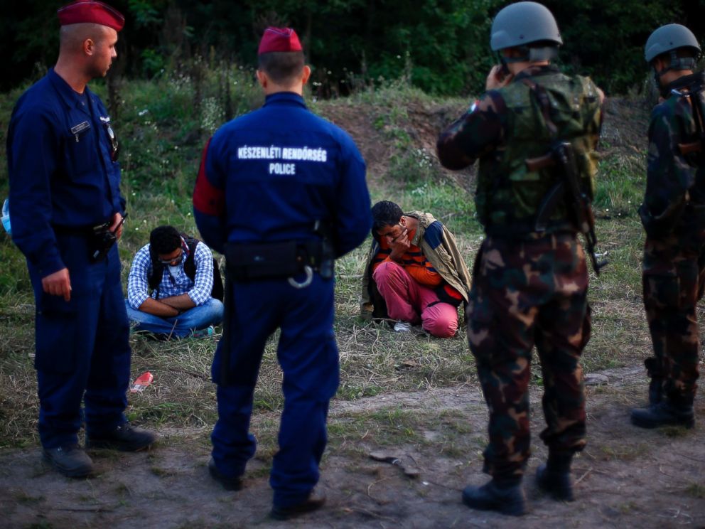 PHOTO: Migrants sit on the ground after they were arrested by Hungarian authorities after they tried to cross the border between Serbia and Hungary in Roszke, Hungary, Sept. 15, 2015.