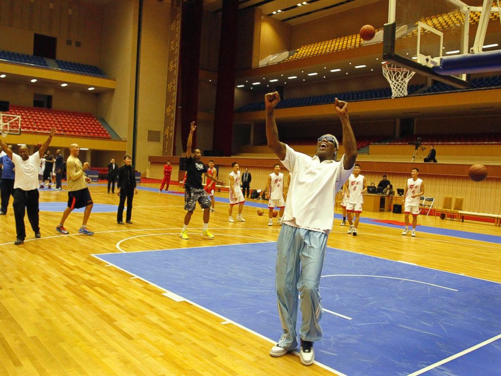 PHOTO: Dennis Rodman cheers after a fellow U.S. basketball player makes a jump shot during a practice session with North Korean players in Pyongyang, North Korea on Jan. 7, 2014.