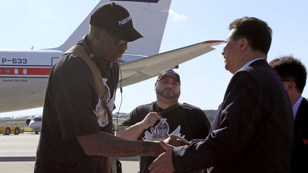 PHOTO: Former NBA star Dennis Rodman, left, is greeted by Son Kwang Ho, vice-chairman of North Koreas Olympic Committee, at Pyongyang airport, North Korea on Sept. 3, 2013.