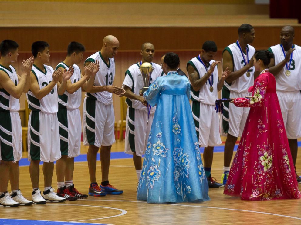PHOTO: U.S. basketball player Doug Christie is handed a trophy as North Korean players applaud at the end of an exhibition basketball game at an indoor stadium in Pyongyang, North Korea on Jan. 8, 2014.