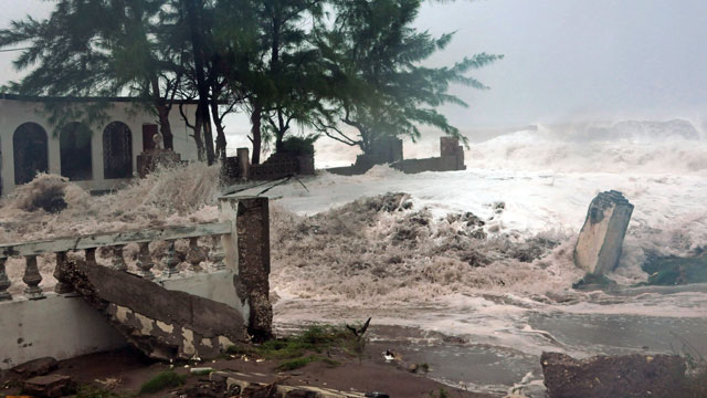 PHOTO: Waves, brought by Hurricane Sandy, crash on a house in the Caribbean Terrace neighborhood in eastern Kingston, Jamaica, Wednesday, Oct. 24, 2012.
