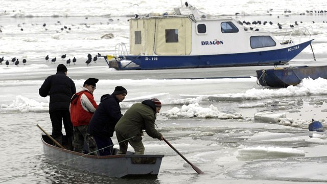 PHOTO: People break the ice on a frozen part of Danube River, in Belgrade, Serbia, Feb. 20, 2012.