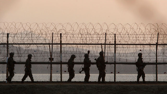 PHOTO: South Korean army soldiers patrol along a barbed-wire fence near the border village of Panmunjom in Paju, South Korea on March 26, 2013 after a warning from North Koreas military that its artillery and rocket forces are at their highest-level comb
