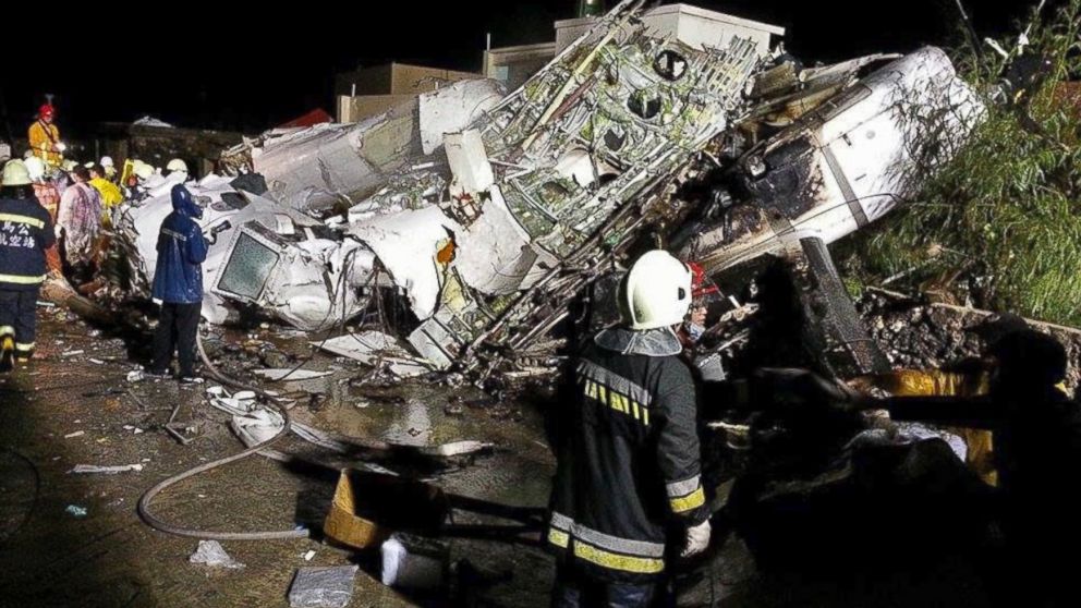 PHOTO: Rescue workers survey the wreckage of TransAsia Airways flight GE222 which crashed while attempting to land in stormy weather on the Taiwanese island of Penghu, July 23, 2014. 