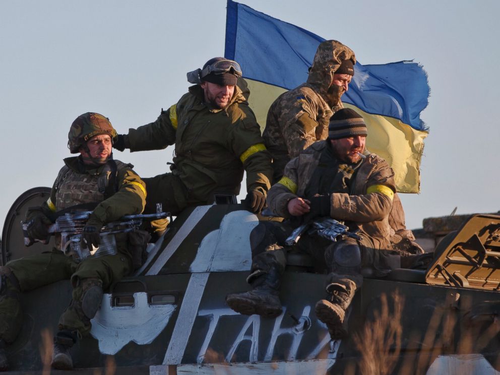 PHOTO: Ukrainian troops ride on an armored vehicle outside Artemivsk, Ukraine, while pulling out of Debaltseve, Feb. 18, 2015.
