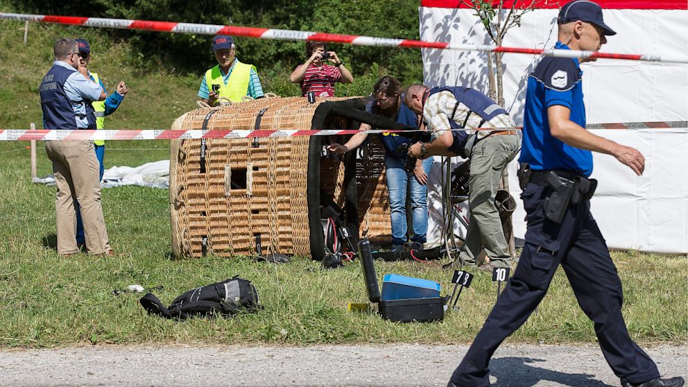 PHOTO: Swiss police officers inspect a hot air ballon after it crashed