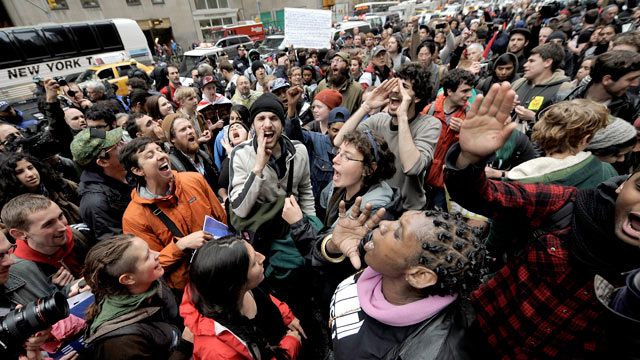 PHOTO: People gather on a sidewalk during a May Day protest in New York, New York, May 1, 2012. People around the world are gathering for May Day protests against austerity measures and calling for higher wages.