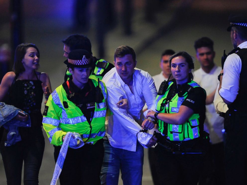 PHOTO: Police escort a member of public as they clear the scene of a terror attack on London Bridge in central London on June 3, 2017.