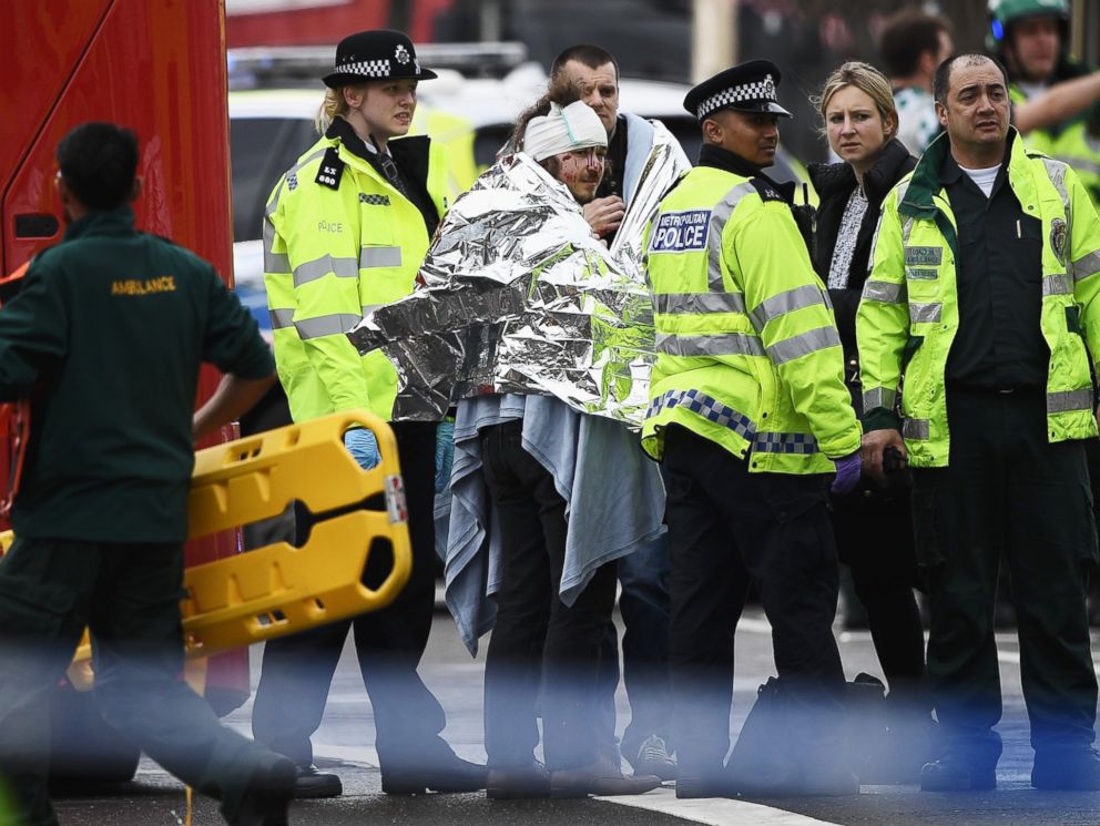 PHOTO: A member of the public is treated by emergency services near Westminster Bridge and the Houses of Parliament on March 22, 2017 in London.