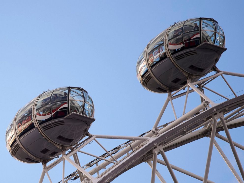 PHOTO: People are seen inside the pods of the London Eye opposite the Houses of Parliament after an incident in central London on March 22, 2017.