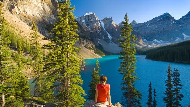 PHOTO: Woman sitting on rock at Lake Moraine.