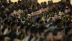Afghan defense officers attend a security handover ceremony at a military academy outside Kabul, June 18, 2013.