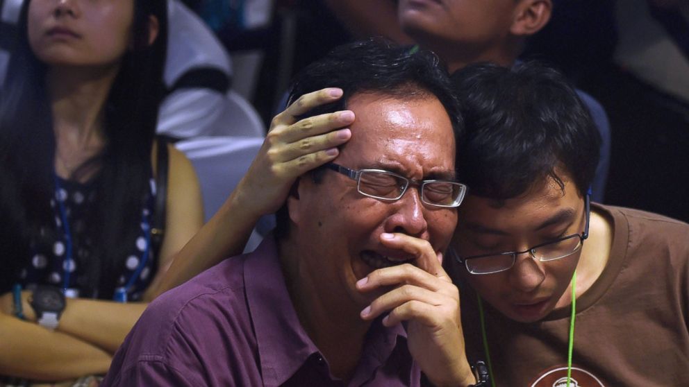 PHOTO: Family members of passengers aboard AirAsia flight QZ8501 react after watching news reports inside the crisis center set up at Juanda International Airport in Surabaya, Indonesia on Dec. 30, 2014. 