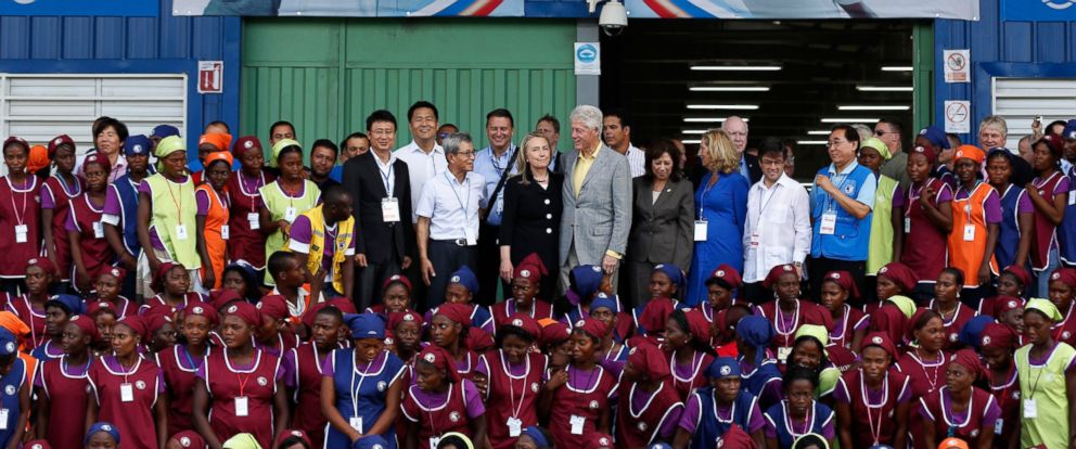 PHOTO: Hillary Clinton and Bill Clinton (center) pose with workers at the grand opening ceremony of the new Caracol Industrial Park in Caracol, Haiti, Oct. 22, 2012.