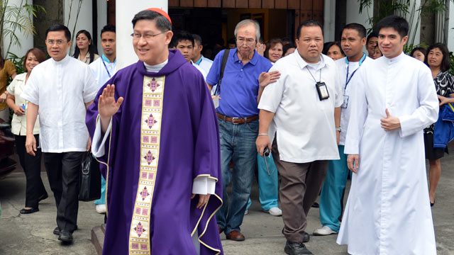PHOTO: Roman Catholic Archbishop of Manila, Cardinal Luis Antonio Tagle, waves to photographers after a service at a church in Manila, Feb. 13, 2013.