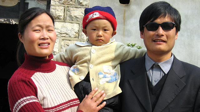 PHOTO: Chen Guangcheng, right, stands with his wife and son Chen Kerui outside their home in Dondshigu village, Shandong province, in this 2005 file photo.