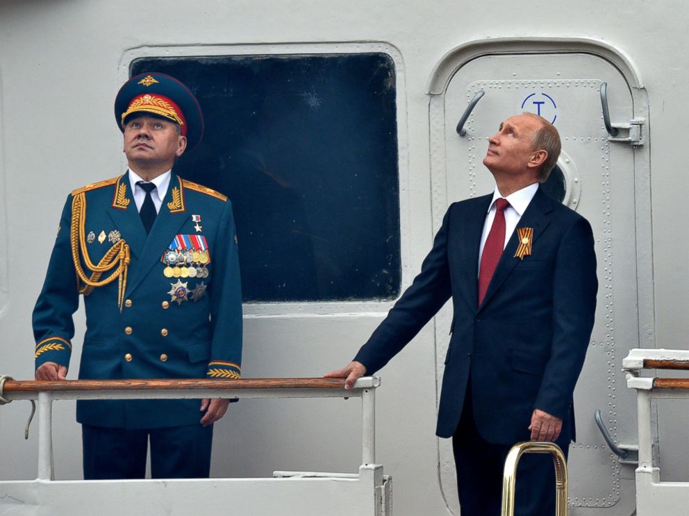 PHOTO: Russias President Vladimir Putin, center and Defence Minister Sergei Shoigu, left, watch Russian Air Force parade during their visit to the Crimean port of Sevastopol, May 9, 2014.