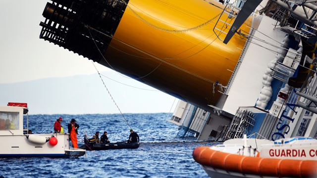 PHOTO: Boats patrol near the Costa Concordia, Jan. 15, 2012, after the cruise ship ran aground, off the coast of Tuscany, Italy.