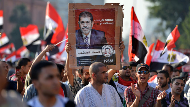 PHOTO: Egyptians celebrate at Cairos Tahrir Square the victory of Mohamed Morsi (poster) in the presidential elections on June 24, 2012.
