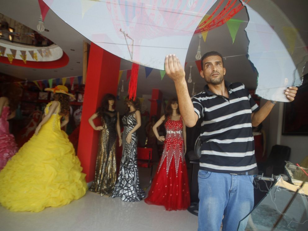 PHOTO: A Palestinian man removes the broken glass from his damaged shop which sells womens clothing, in Rafah town, in the southern Gaza Strip, on Aug. 5, 2014, as a 72-hour truce agreed by Israel and the ruling Hamas movement went into effect.
