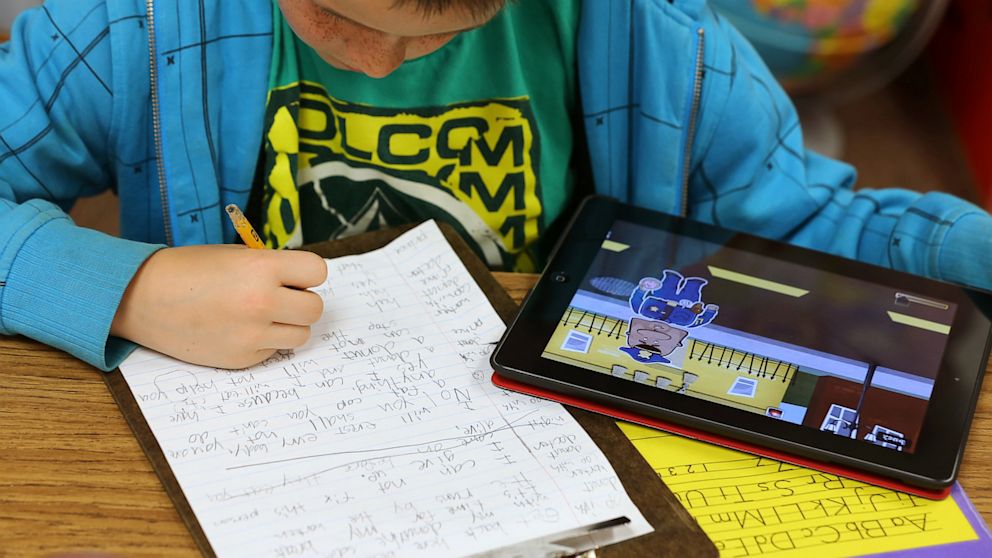 PHOTO: A second grader works on an Apple Inc. iPad as part of his classroom work at Park Lane Elementary school, in the Canyons School District, in Sandy, Utah, U.S. on May 20, 2013.