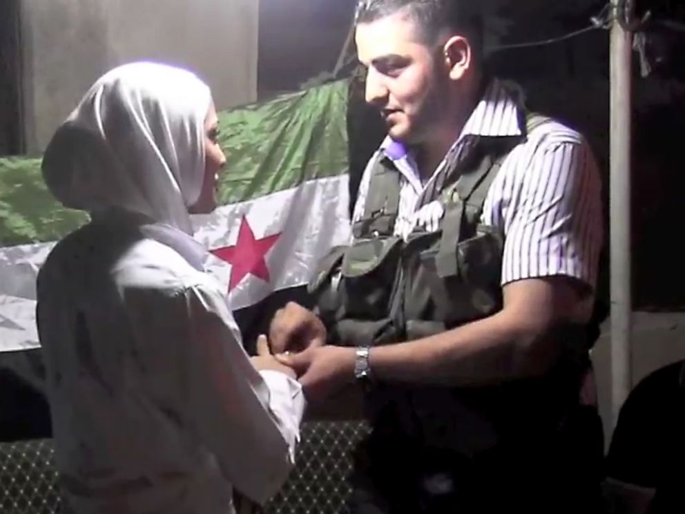 PHOTO:An image grab taken from AFP TV shows Syrian rebel sniper Abu Khaled exchanging rings with his bride Hanan during their wedding ceremony in Aleppo, Aug. 31, 2012.