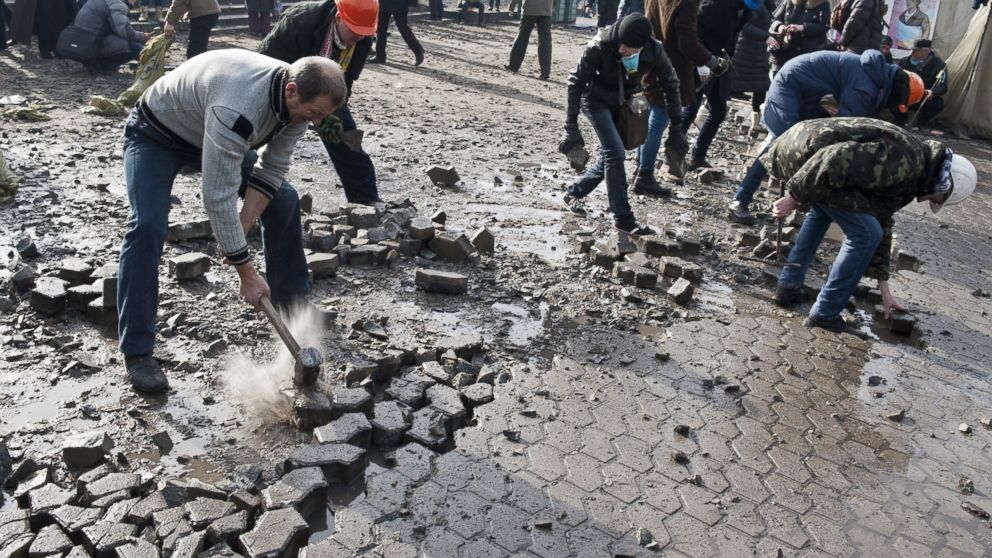 PHOTO: Anti-government protesters dig up cobblestones to use them as rocks against riot police on Kievs Independence square, Feb. 19, 2014.