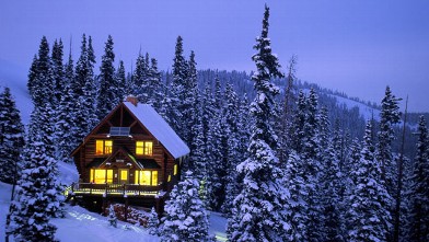 PHOTO: A snow-covered ski cabin in the mountains is shown.