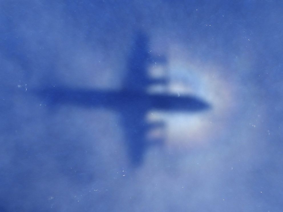 PHOTO: This shadow of a Royal New Zealand Air Force P3 Orion aircraft is seen on low cloud cover while it searches for missing Malaysia Airlines flight MH370, over the Indian Ocean on March 31, 2014.