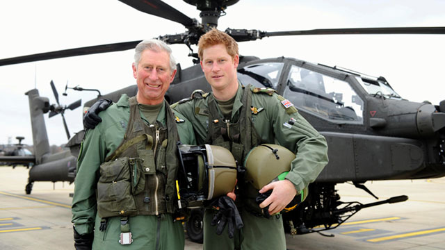 PHOTO: Prince Harry, with his father, Prince Charles, the Prince of Wales, stand in front of an Apache Helicopter at Middle Wallop on the Apache Conversion Course, April 17, 2011.