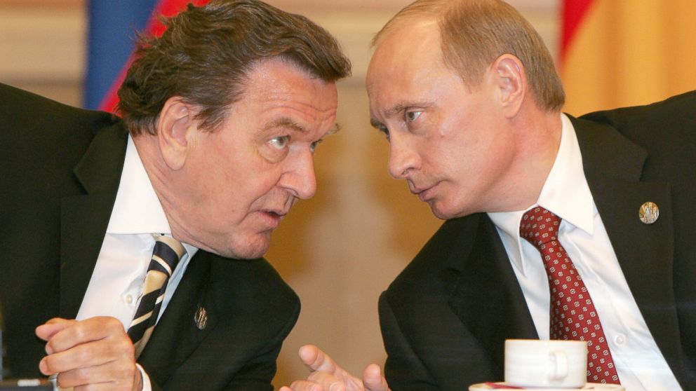 PHOTO: Russian President Vladimir Putin (R) talks to and German Chancellor Gerhard Schroeder during their meeting in Moscow, May 9, 2005.