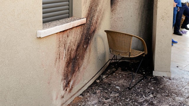 PHOTO: A picture shows the damage outside a house after a rocket launched from the Gaza Strip hit the southern city of Sderot on March 21, 2013.