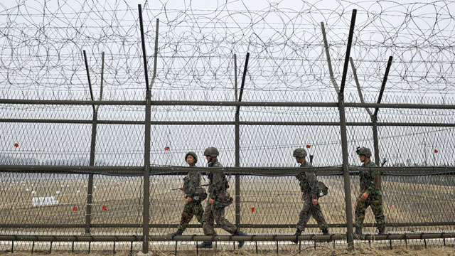 PHOTO: South Korean soldiers patrol along a military fence near the demilitarized zone (DMZ) dividing the two Koreas in the border city of Paju on April 5, 2013.