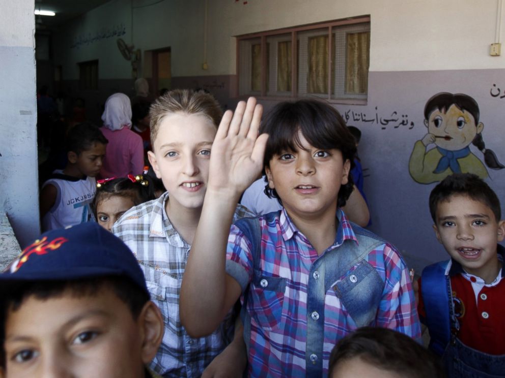PHOTO: Syrian children walk in a corridor at a school on Sept. 14, 2014 on the first day of the new school year in the Syrian capital Damascus.