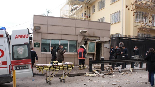 PHOTO: People stand outside the entrance of the US embassy in Ankara, Feb. 1, 2013, after a blast killed two security guards and wounded several other people.