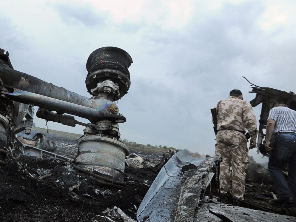 PHOTO: Men explore the wreckage of the Malaysian airliner that crashed in east Ukraine while traveling from Amsterdam to Kuala Lumpur on July 17, 2014.