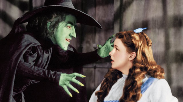 PHOTO: A publicity shot of Margaret Hamilton as The Wicked Witch, arms extended towards Judy Garland as Dorothy Gale, in Witches Castle from the original 1938 film "The Wizard of Oz".