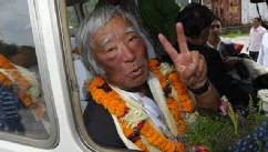PHOTO: Japanese adventurer Yuichiro Miura gestures upon his arrival at Tribhuvan Airport in Kathmandu on May 26, 2013, after summitting Mount Everest.