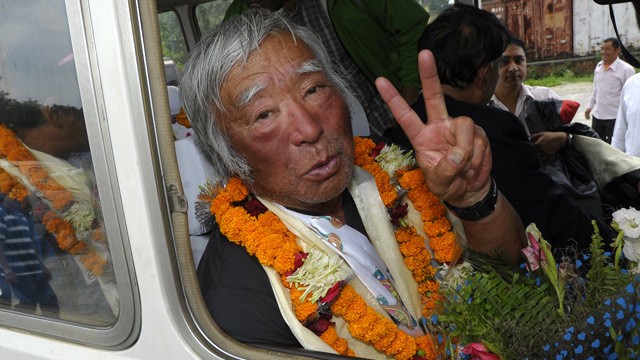 PHOTO: Japanese adventurer Yuichiro Miura gestures upon his arrival at Tribhuvan Airport in Kathmandu on May 26, 2013, after summitting Mount Everest.