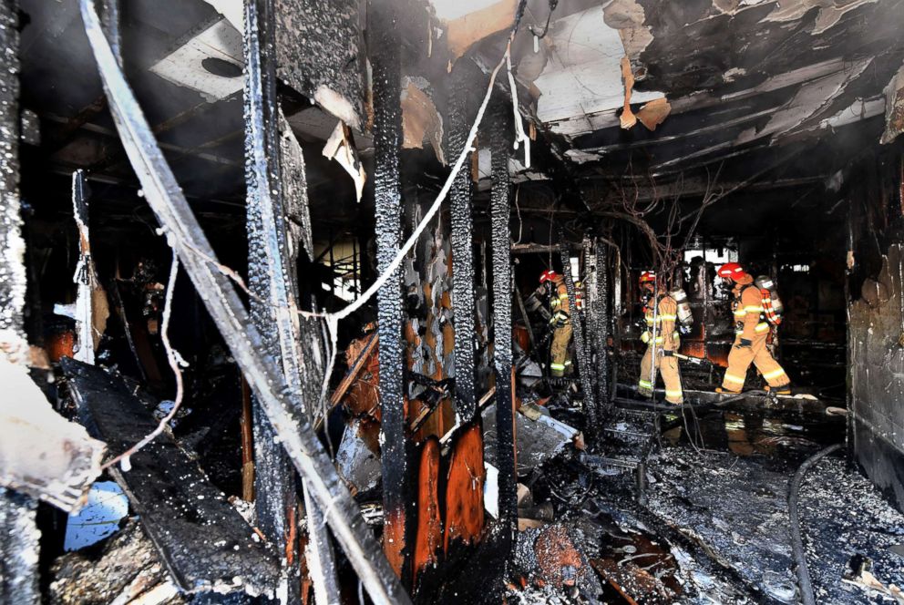 PHOTO: Firefighters inspect a burnt hospital after a fire on Jan. 26, 2018 in Miryang, South Korea, where at least 37 people died.