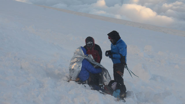 PHOTO: Rescuers put climbers in body heat wraps after at least nine climbers died and nine were injured following an avalanche July 12, 2012 in the French Alps.