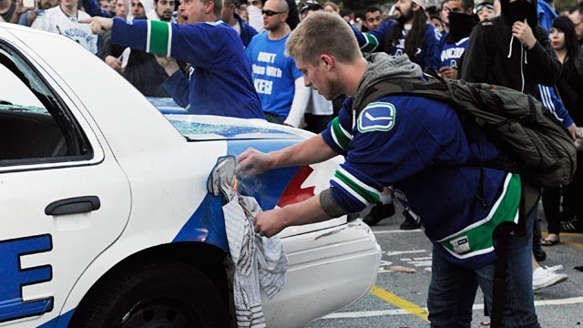 PHOTO: Nathan Kotylak lights a rag stuffed in the gas cap of a police car