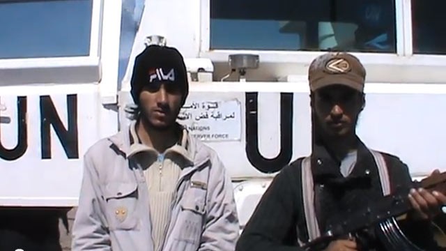 PHOTO: In this image from video published March 6, 2013, a man who claims to be a member of the "Martyrs Brigade of Yarmouk" says the convoy will not be released until forces loyal to Assad withdrew from the village of Jamla, a mile east of the ceasefire