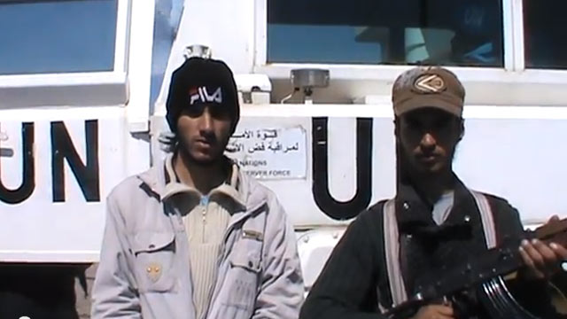 PHOTO: In this image from video published March 6, 2013, a man who claims to be a member of the "Martyrs Brigade of Yarmouk" says the convoy will not be released until forces loyal to Assad withdrew from the village of Jamla, a mile east of the ceasefire