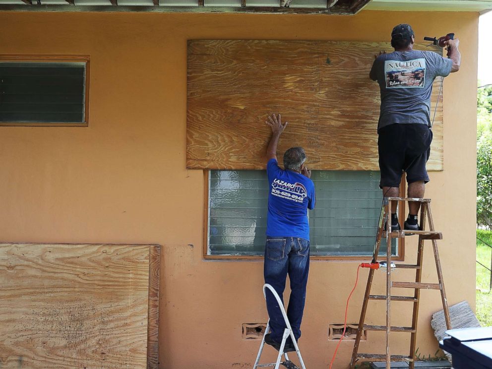 PHOTO: People put up shutters as they prepare a family members house for Hurricane Irma, Sept. 6, 2017, in Miami.