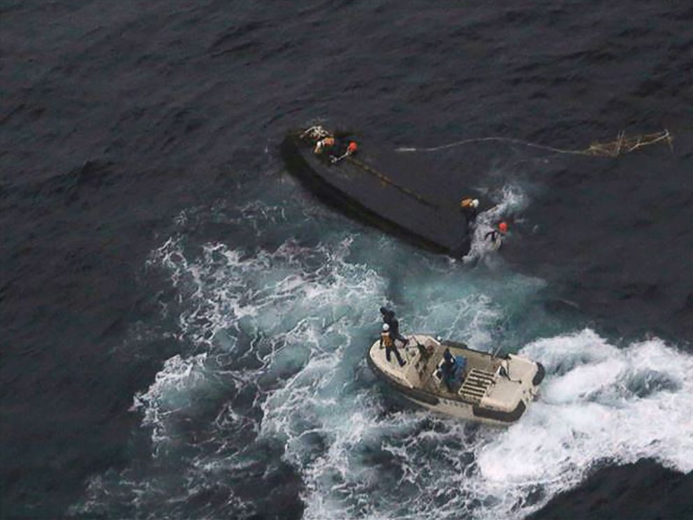 PHOTO: A Japan Coast Guard rescue team approaches a capsized North Korean boat (top) on the Sea of Japan (East Sea), about 225 miles northwest of the Noto Peninsula in Ishikawa Prefecture, Nov. 15, 2017.