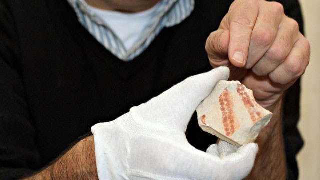 PHOTO: Archaeologist Nicholas Conard holds a painted stone in his hand at Hohentuebigen Palace in Tuebingen, Germany, Nov. 8, 2011.