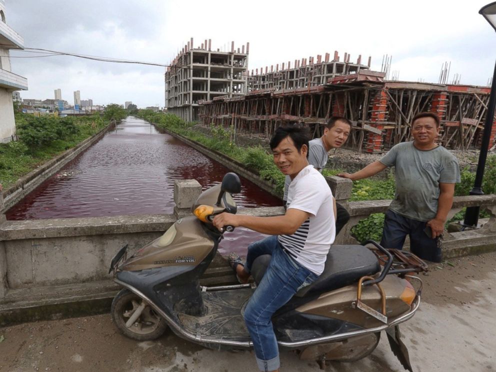 PHOTO: The river in Xinmeizhou village in eastern Chinas Zhejiang province quickly filled up with the red colored liquid which had a strange smell, according to villagers, July 25, 2014.