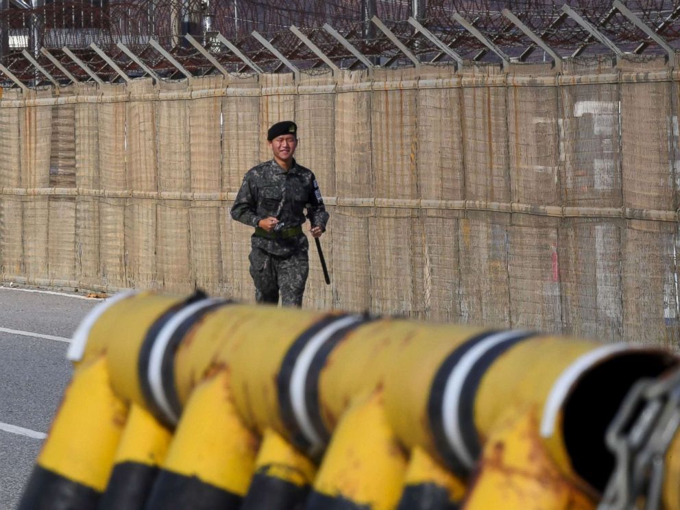 PHOTO: A South Korean soldier runs along a military fence on the road leading to the truce village of Panmunjom at a South Korean military checkpoint in the border city of Paju near the Demilitarized Zone (DMZ) dividing the two Koreas, Nov. 14, 2017.